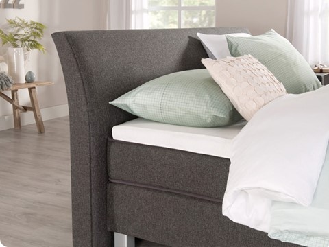 een bed met kussens erop